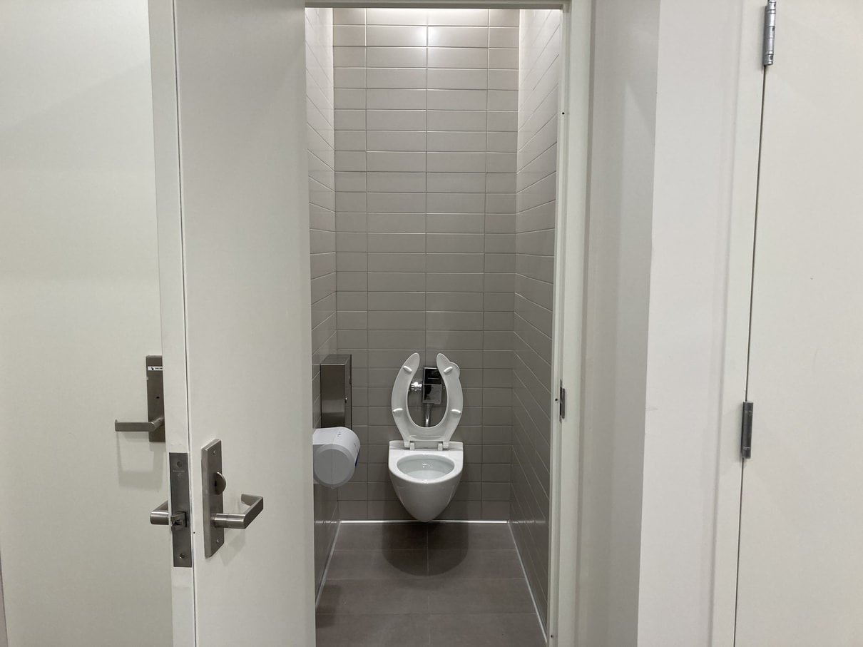 Interior of stall-room in bathroom with toilet.
